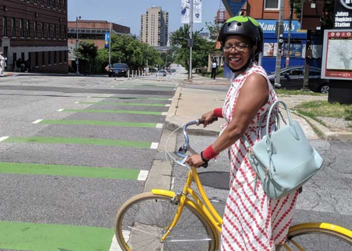 Robbyn riding her bike on Broadway