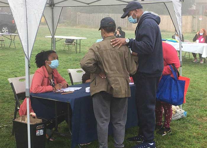 Robbyn volunteers at community service table at event